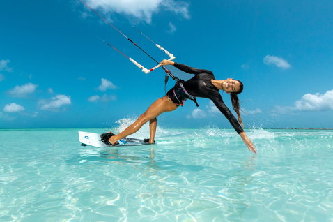 Duotone Soleil SLS twin-tip kiteboard during kitesurfing in a tropical lagoon with shallow turquoise water