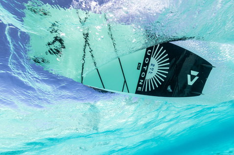 Duotone Soleil SLS twin-tip kiteboard during kitesurfing in tropical ocean with clear water