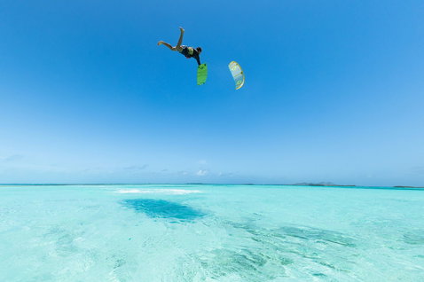 Duotone TS Big Air SLS twin-tip kiteboard during kitesurfing in a tropical lagoon with shallow turquoise water