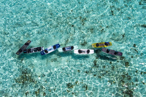 Duotone TS Big Air SLS twin-tip kiteboards in tropical ocean with shallow turquoise water