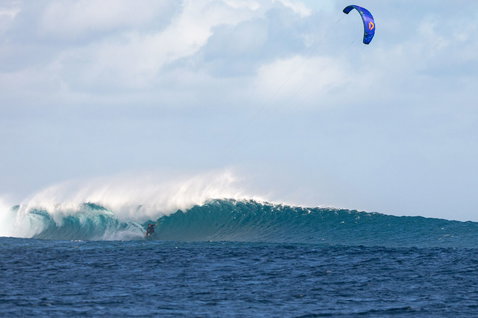 Duotone Blur SLS Concept Blue wave kiteboard during wave riding in the open ocean at a reef break