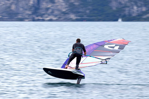 Duotone Falcon Foil D/LAB foil board while foiling on an alpine lake with mountain backdrop