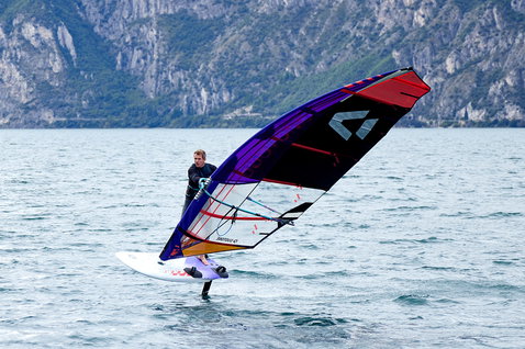 Duotone Falcon Foil D/LAB windsurf board during foiling on an alpine lake