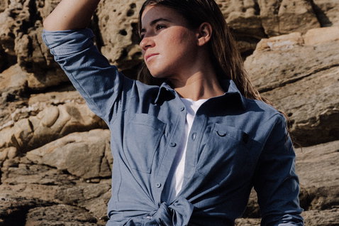 Duotone Apparel Shirt LS True unisex long sleeve shirt during standing pose at a rocky coastal cliff in slate blue