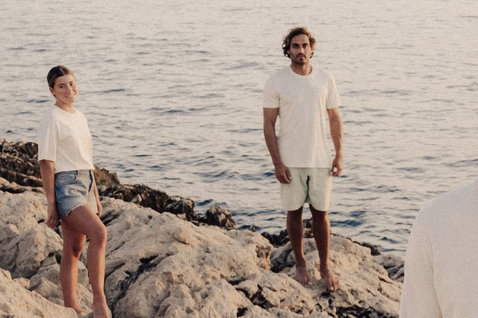 Duotone Tee SS CB Concept Blue short sleeve t-shirt at a rocky coastline by the sea in natural off-white
