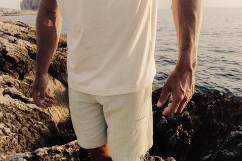 Duotone Apparel Tee SS CB Concept Blue short sleeve t-shirt during a standing pose at rocky coastal cliffs by the ocean
