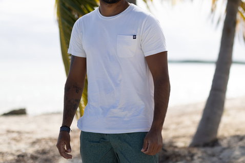 Duotone Apparel Tee Pocket SS Concept Blue short sleeve t-shirt for men in undyed natural off-white on tropical beach with palm trees