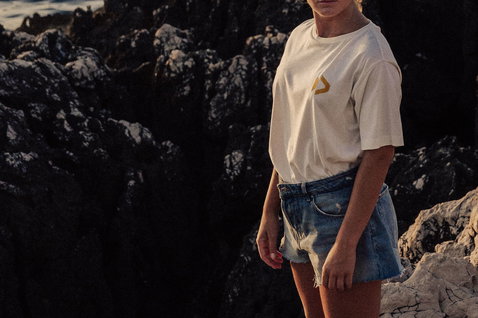 Duotone Apparel Tee SS CB Concept Blue women's t-shirt posing at rocky coastal cliffs