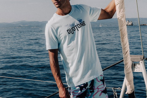 Duotone Apparel Tee SS True Team men short sleeve t-shirt while standing on a sailboat with mountainous coastline