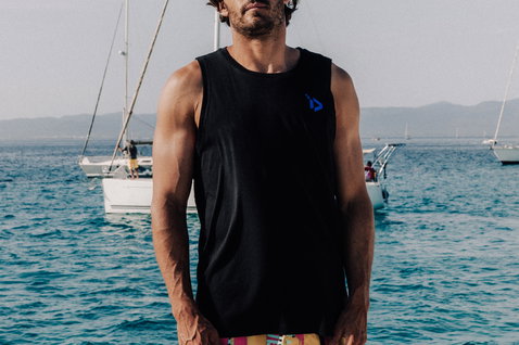 Duotone Apparel Tank True men tank top worn while standing at the ocean beach