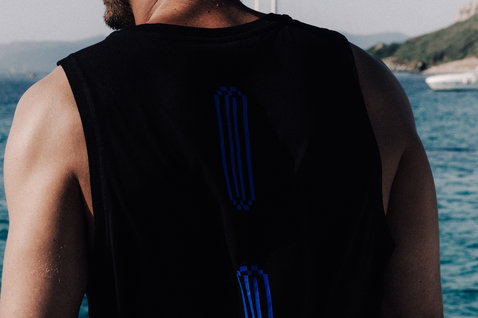 Duotone Apparel Tank True men tank top in black with royal blue at the ocean coast