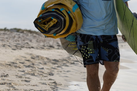 Duotone Apparel Boardshorts DT Originals 19inch men during kitesurfing at a sandy ocean beach