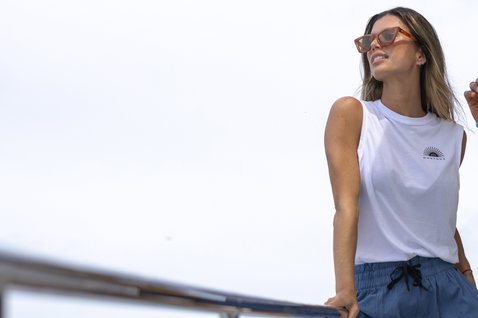 Duotone Apparel Tank True women tank top during a standing pose on a boat deck by the coast