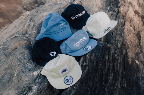 Duotone New Era Adjustable FADE cap group shot in black, light blue and cream on rocky surface