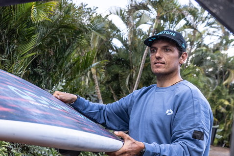 Cap during windsurfing at Maui Hawaii with palm trees in the background