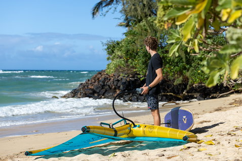 Duotone Lazepump elektrische Luftpumpe beim Aufpumpen eines Wings am Strand auf Maui