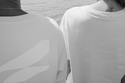 Duotone Concept Blue organic cotton T-shirt with back graphic print worn at the ocean