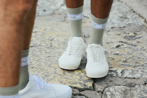 Chaussettes Duotone Originals Light en dusty forest portées avec des baskets blanches sur pavés