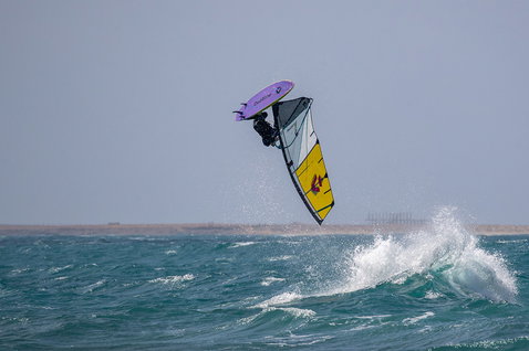 Duotone Grip [Tri] SLS windsurf board during wave riding at the ocean beach