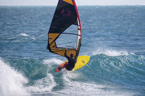 Duotone Ultra FreeWave SLS windsurf board during wave riding on the open ocean wave break