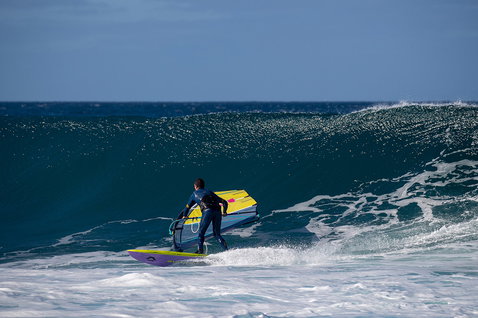 Duotone Ultra Grip [Quad] windsurf board during wave riding at an ocean beach