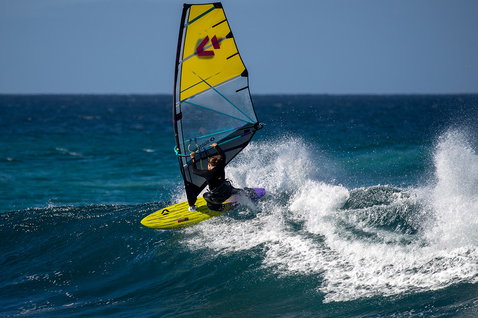 Duotone Ultra Grip [Quad] SLS windsurf board during wave riding on the ocean