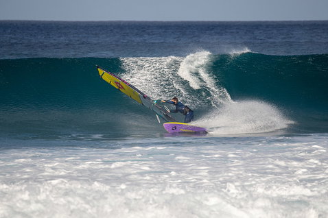 Duotone Ultra Grip [Quad] SLS windsurf board during wave riding at an ocean beach