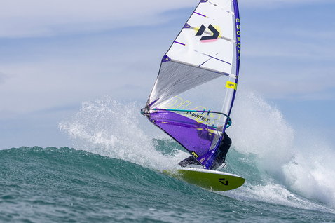 Duotone Super Hero D/LAB wave sail during wave riding in an ocean wave break