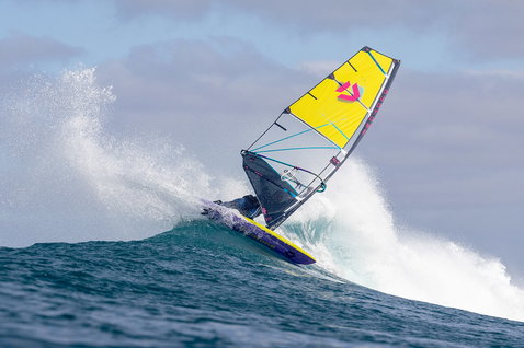 Duotone Super Hero SLS wave sail during wave riding at an ocean wave break