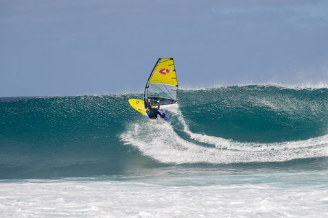 Duotone Super Hero SLS wave sail during wave riding at an open ocean surf break