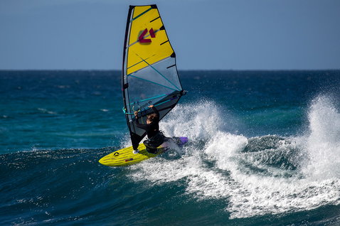 Duotone Super Hero SLS wave sail during windsurfing at the ocean beach with open sea waves