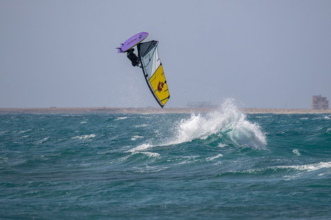Duotone Super Hero SLS wave sail during wave riding at the ocean beach