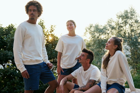 Duotone Apparel Concept Blue organic cotton T-shirt in natural cream worn during outdoor lifestyle shoot