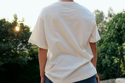 Duotone Concept Blue women's T-shirt in natural off-white organic cotton worn outdoors at golden hour