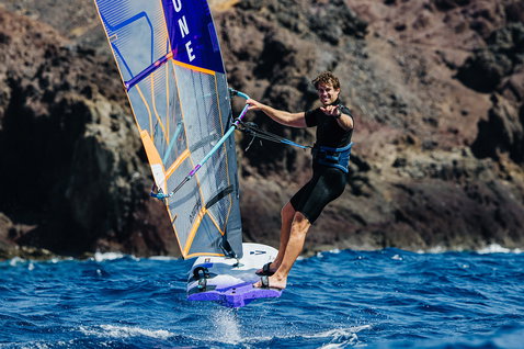 Duotone Falcon_Foil D/LAB windsurf board during foiling at a volcanic rocky coastline