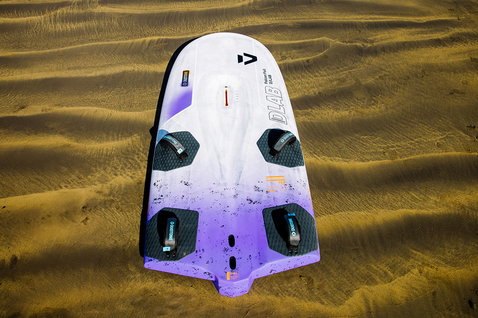Duotone Falcon Foil D/LAB windsurf board 159L in white with violet and gold on a sandy beach