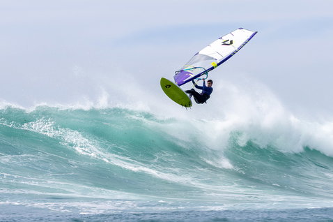 Duotone Ultra Grip [Tri] D/LAB Customized windsurf board during wave riding at the beach