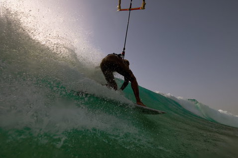 Duotone Whip SLS wave kiteboard during kitesurfing on an ocean wave