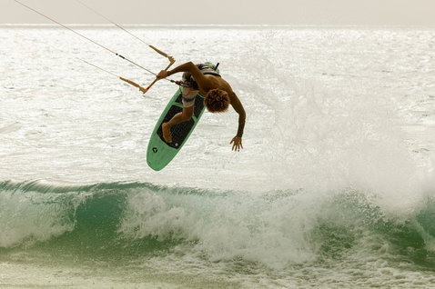 Duotone Whip SLS kite surfboard during kitesurfing at ocean beach