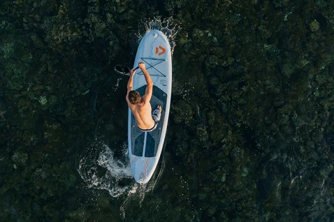 Duotone Flow Air SLS inflatable SUP board during stand-up paddleboarding on the ocean, aerial view