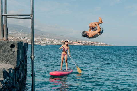 Duotone Grace Air SLS inflatable SUP board during stand-up paddling on the ocean in pink