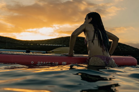 Duotone Grace Air SLS inflatable SUP 11'2 during stand-up paddleboarding at sunset on the ocean