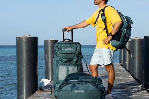 Duotone Combibag travel bag on an ocean pier carried by a kiteboarder departing for a trip