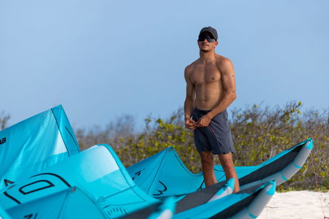 Duotone Evo D/LAB LEI kite during kitesurfing on a tropical beach in cyan
