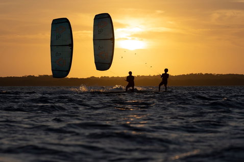 Duotone Evo D/LAB LEI kite during kitesurfing on a tropical lagoon at golden-hour sunset