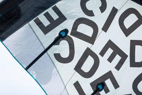 Duotone Dice SLS LEI kite canopy detail with large typographic print in dark charcoal and teal