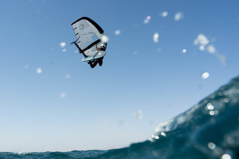 Duotone Sky Style SLS Foilboard beim Wing Foiling über dem Ozean mit spektakulärem Luftsprung