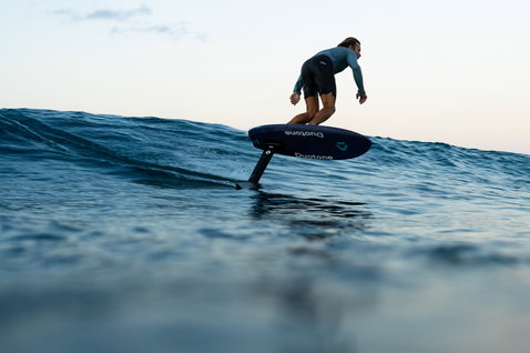 Duotone Crush SLS prone foil board during foiling on an ocean wave in Guadeloupe