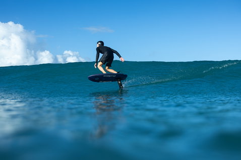 Duotone Crush SLS prone foil board during foiling on the ocean in Guadeloupe in deep teal