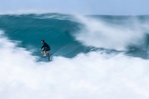 Duotone Crush SLS prone foil board during prone foiling on breaking waves in Guadeloupe